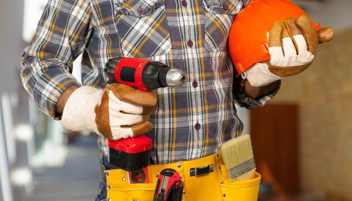 tradesman-holding-drill-and-orange-hard-hat-2026-09-24-23-28-11-utc
